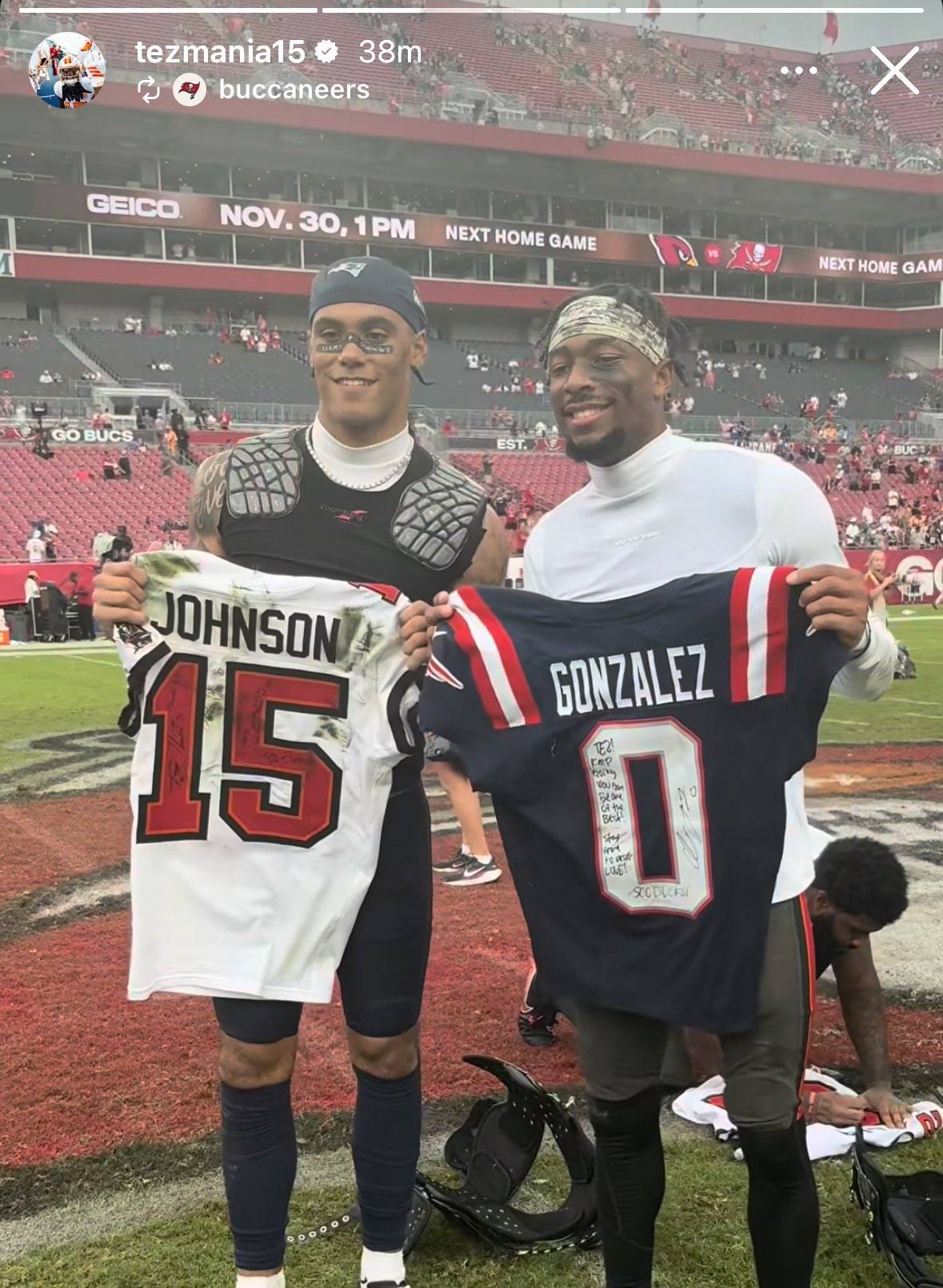 Tampa Bay Buccaneer Tez Johnson poses with New England Patriot Christian Gonzalez to exchange jerseys as former Oregon Ducks.