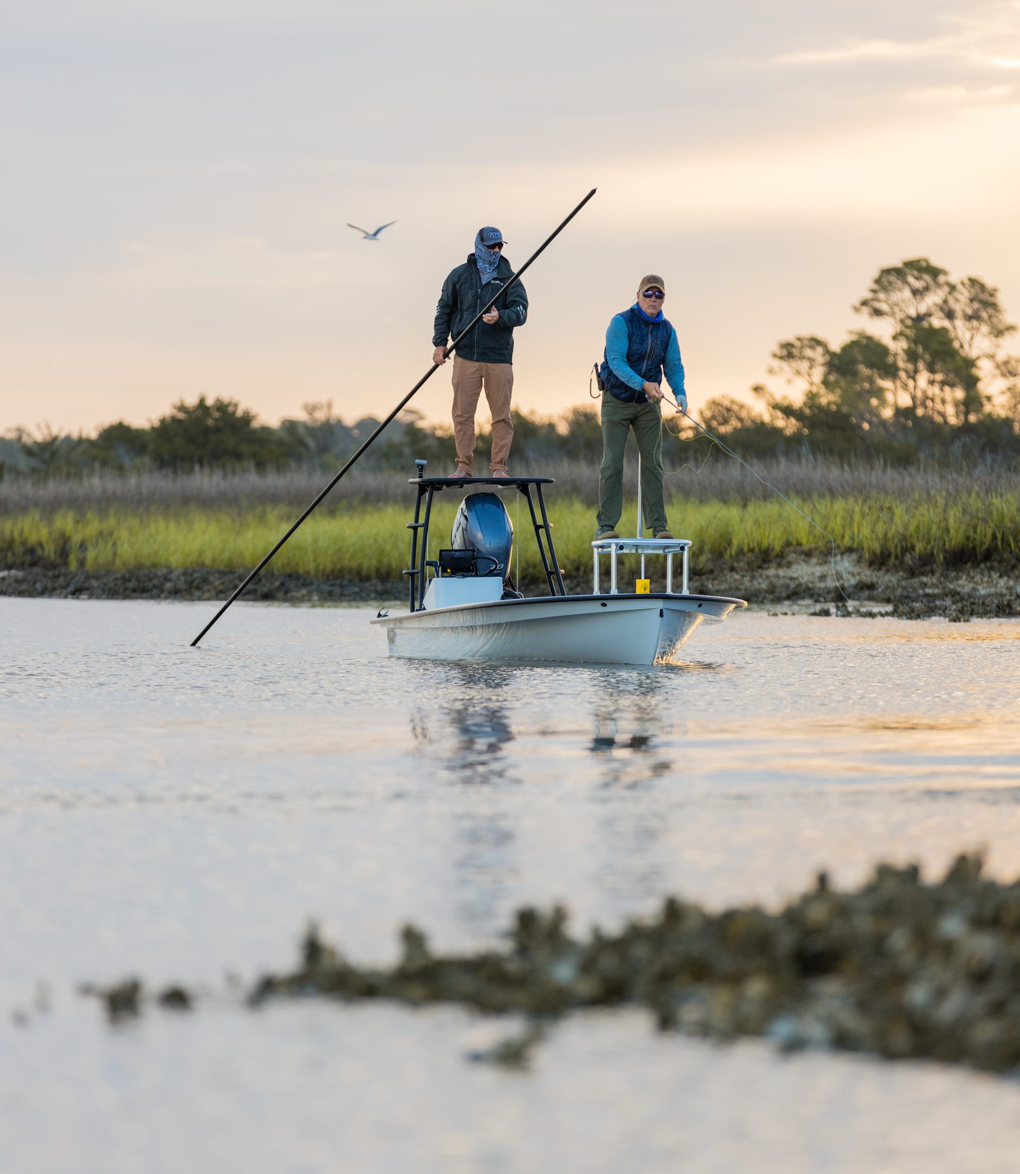 Guide and angler hunting the oyster beds for cruising redfish. Bajio sunglasses cut through the glare helping them see.