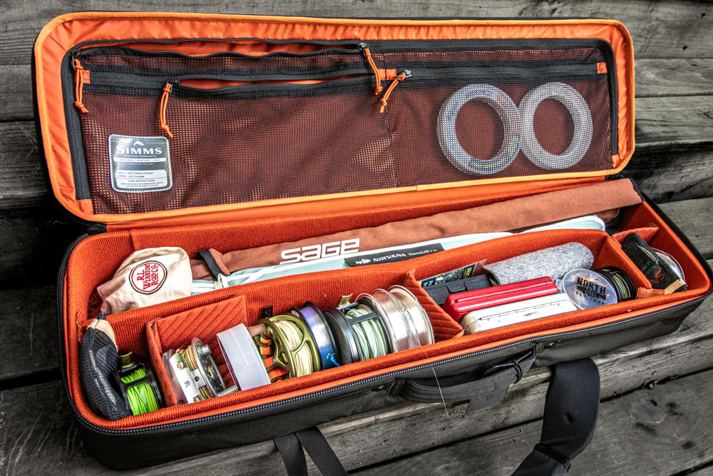 The Simms Tailwind Rod and Reel Vault opened and loaded with fly fishing gear. 