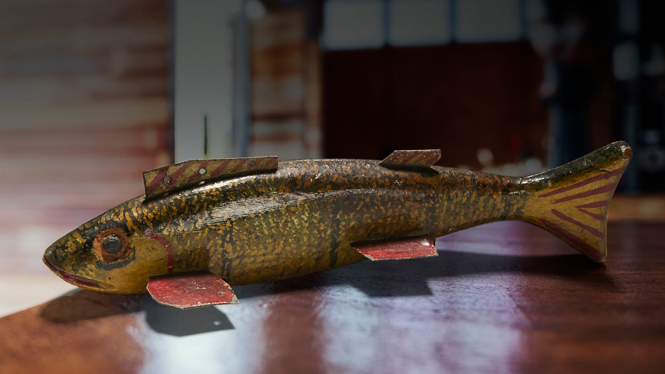 Closeup of an American antique fish decoy from the 1930s, crafted for ice fishing.