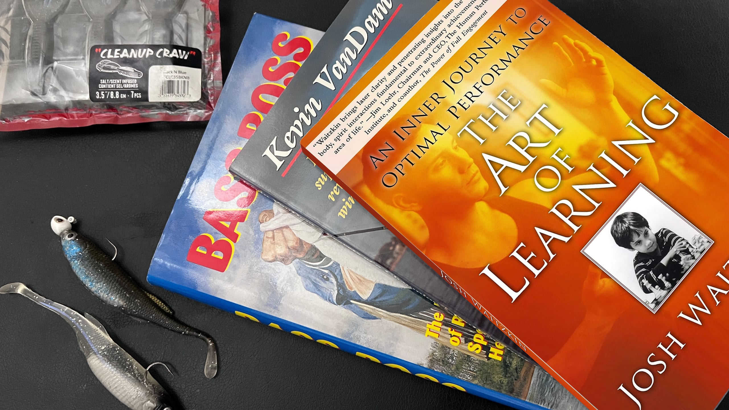The book The Art of Learning displayed as a critical resource for mental strategy in fishing.