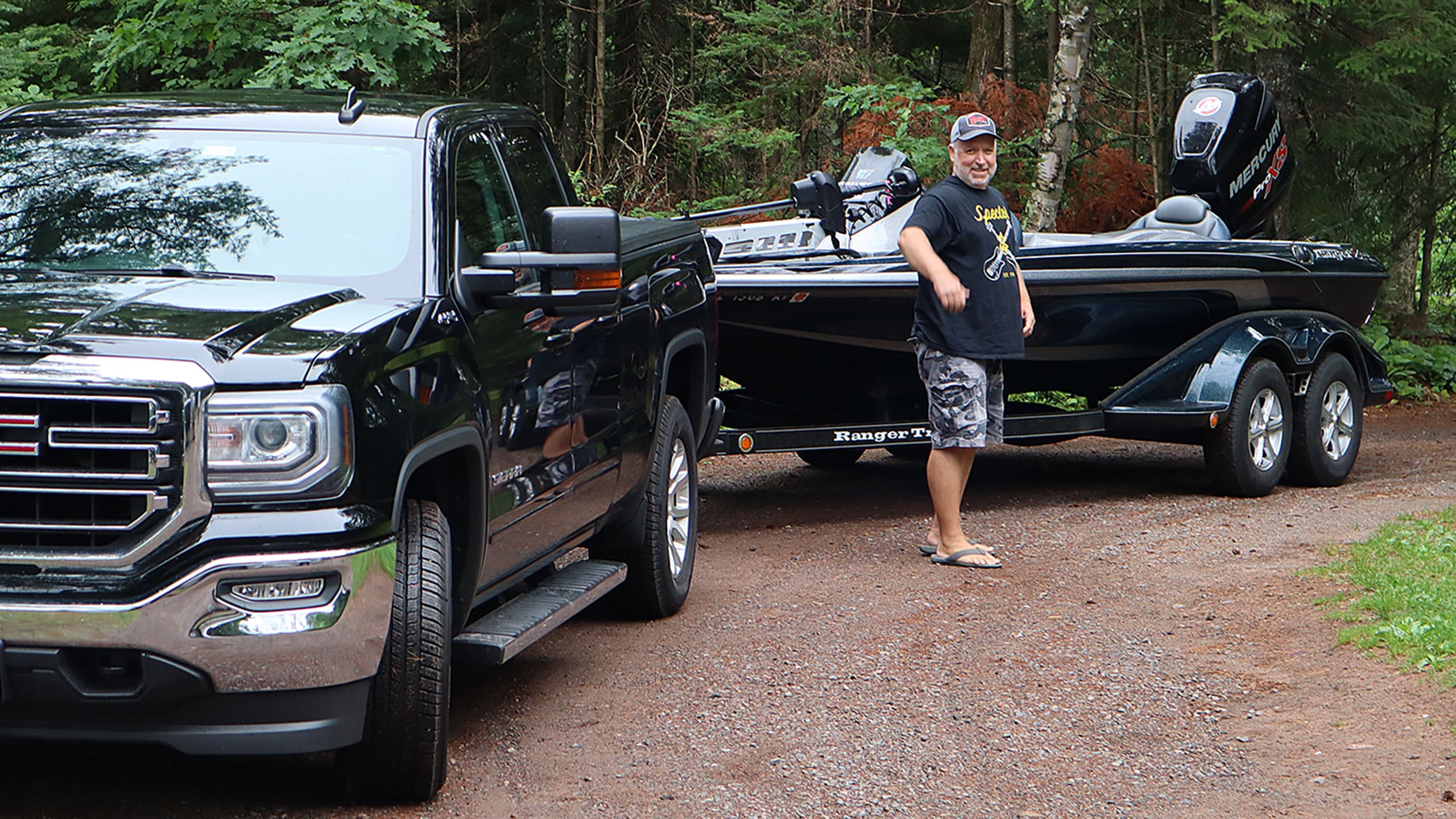 Angler preparing a bass boat in a parking lot, ensuring the ramp is clear for others ready to launch.