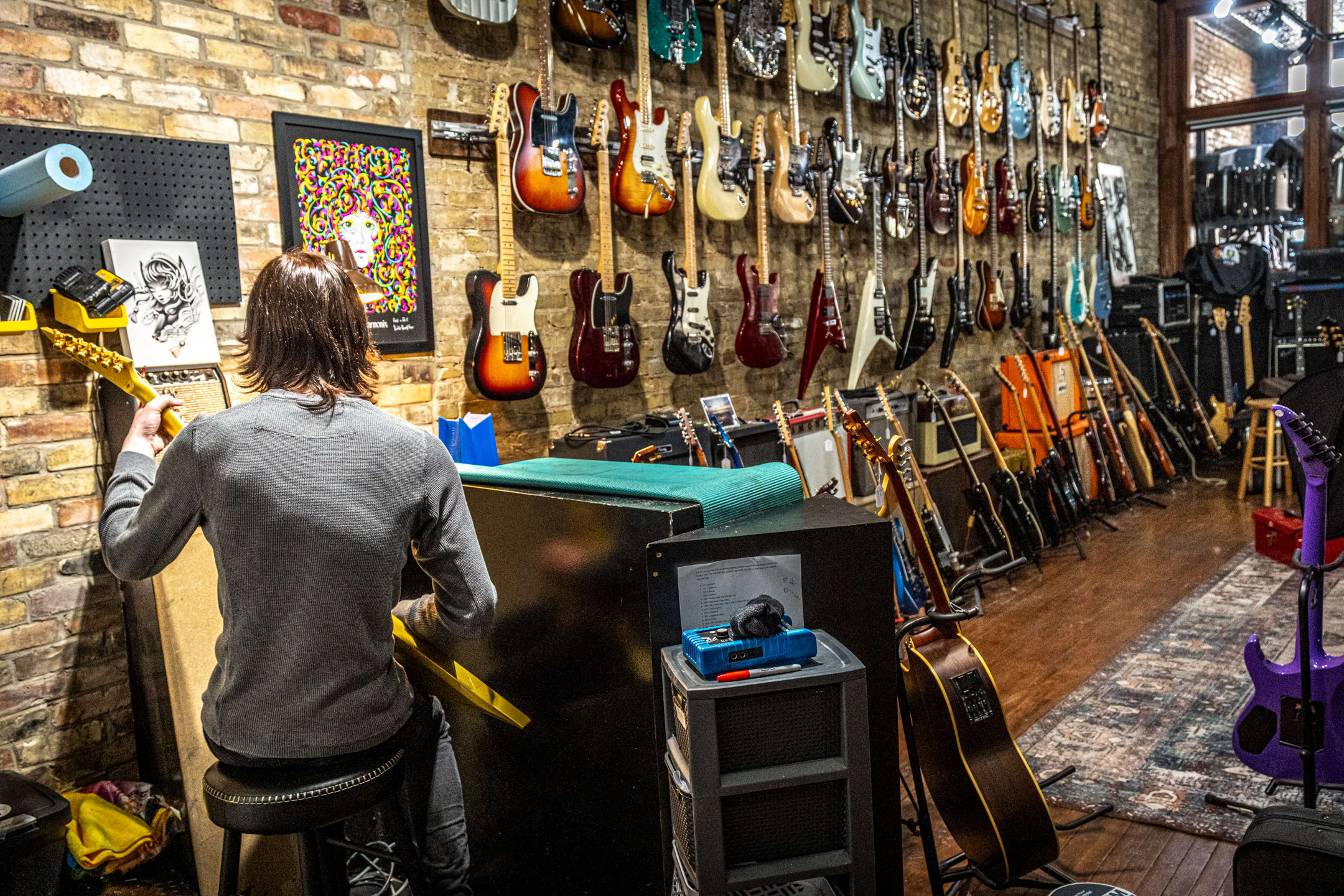 A guitar player in his music shop in Grand Rapids, Michigan. 