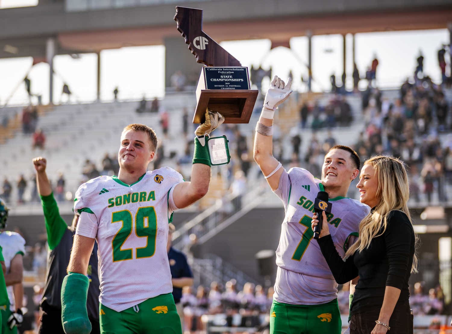 Tommy Sutton (left) and Cash Byington lift the CIF State trophy