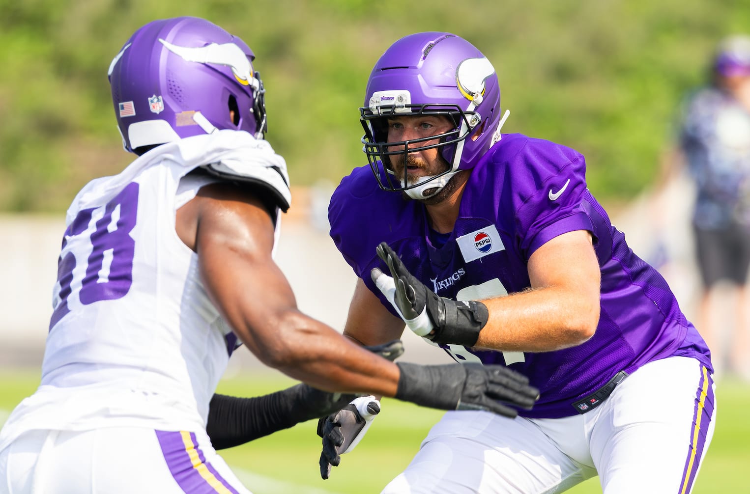 Minnesota Vikings backup tackle Justin Skule (67) blocks Jonathan Greenard (58) during a training camp practice. 
