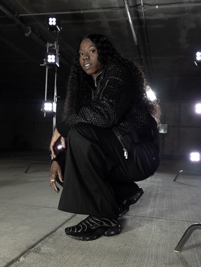 Arike Ogunbowale models diamond-encrusted Nike sneakers.