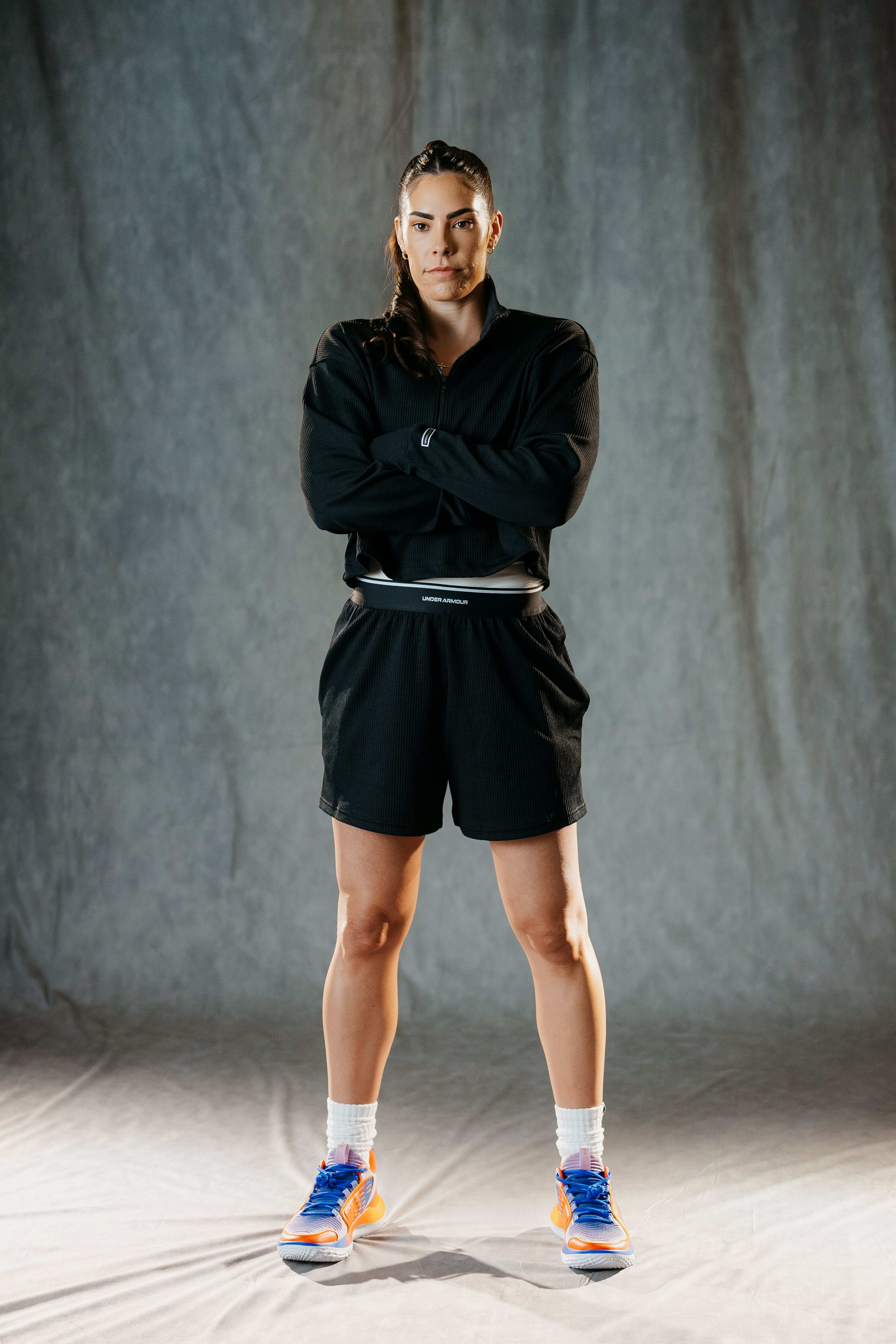 Kelsey Plum models Under Armour shoes.