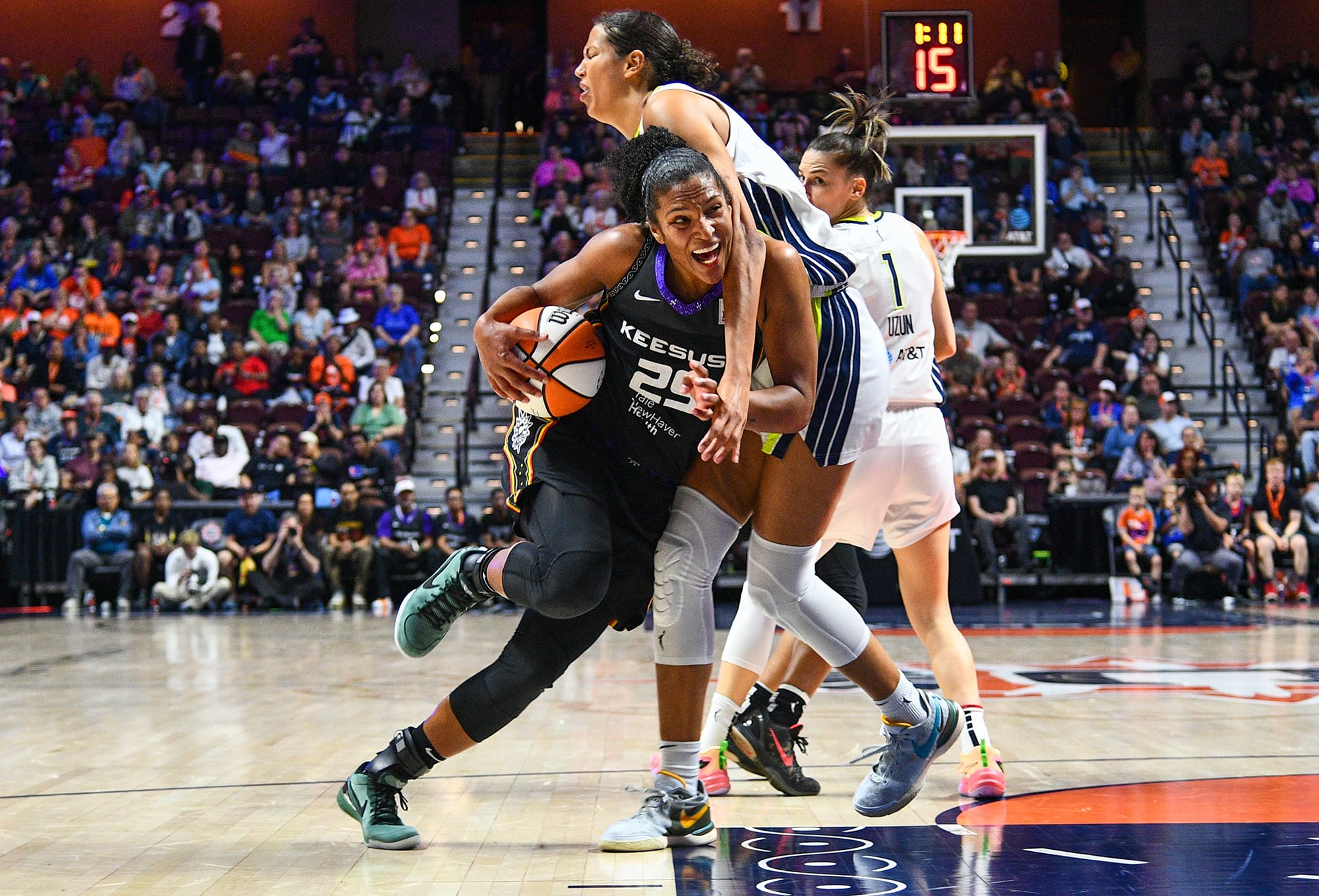 Sun forward Alyssa Thomas draws contact on the way to the net in a game against the Dallas Wings. 