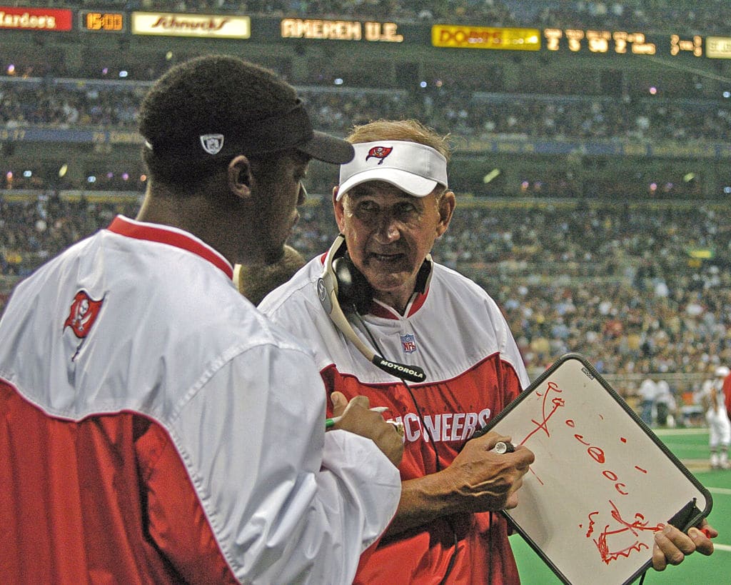 Tampa Bay Buccaneers defensive coordinator Monte Kiffin checks play against the St. Louis Rams October 18, 2004