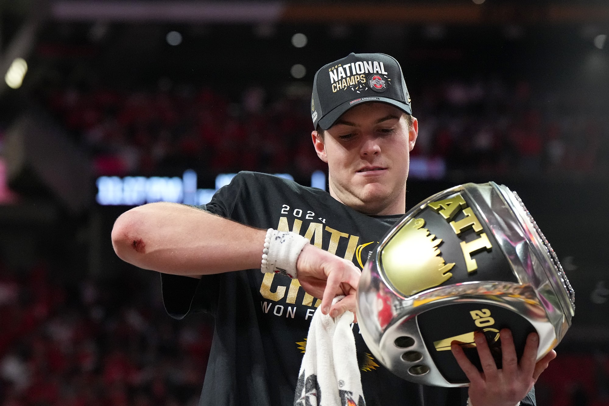 Ohio State quarterback Will Howard admires a jumbo championship ring after the Buckeyes won the national championship.