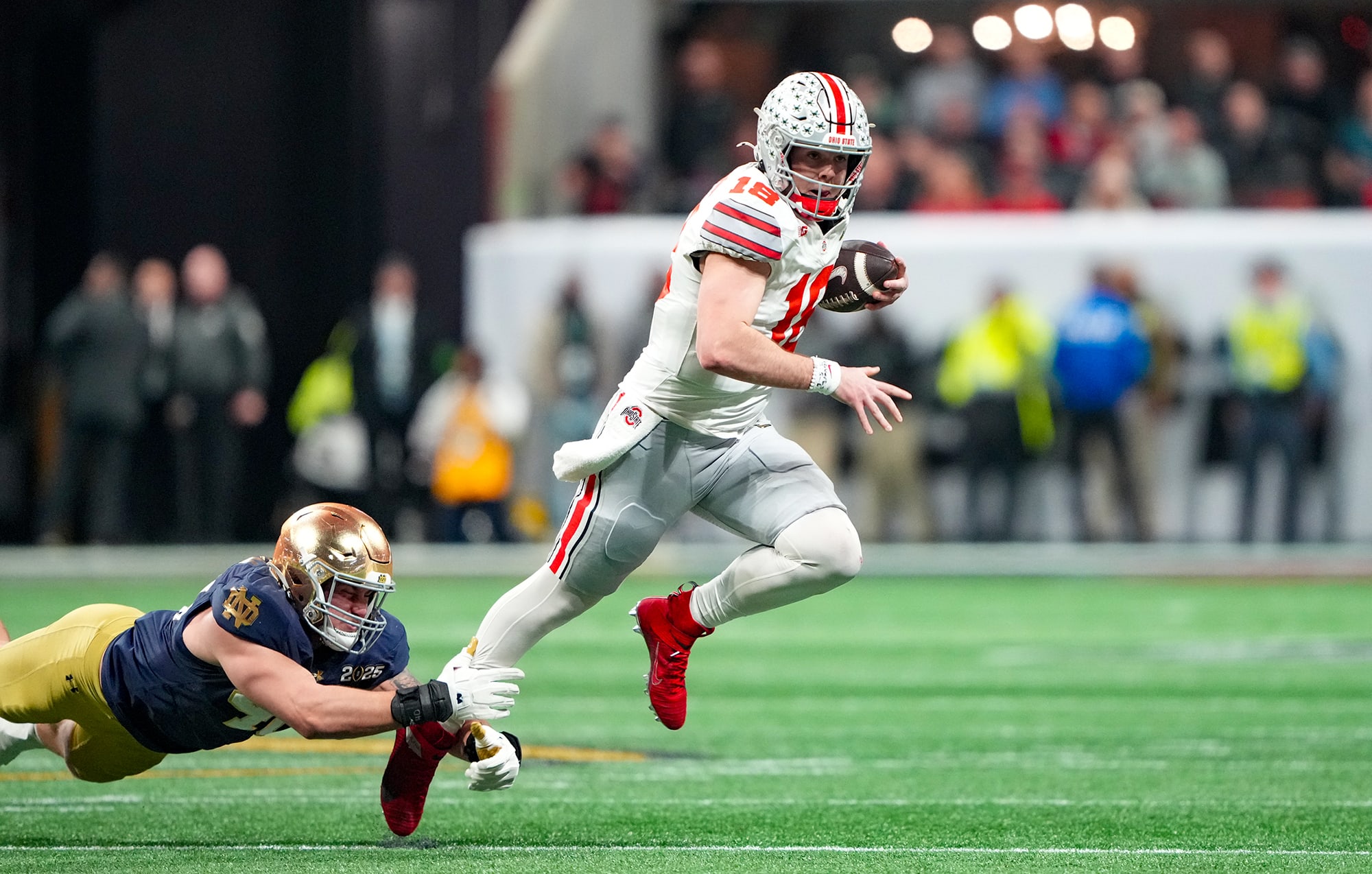 Will Howard tries to escape a tackle during the national championship game.