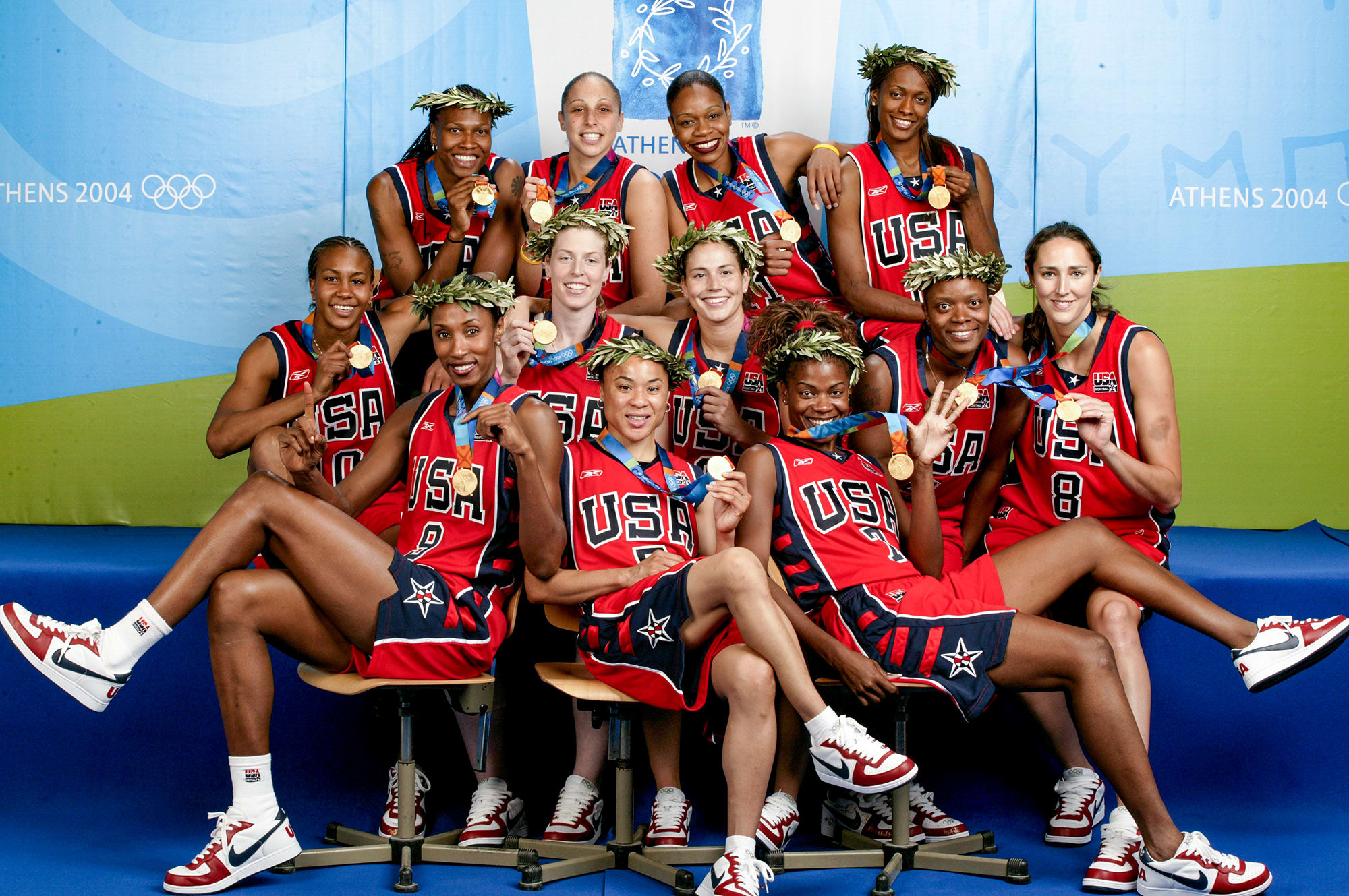 Team USA's women's basketball poses with gold medals at the Athens Games in 2004.