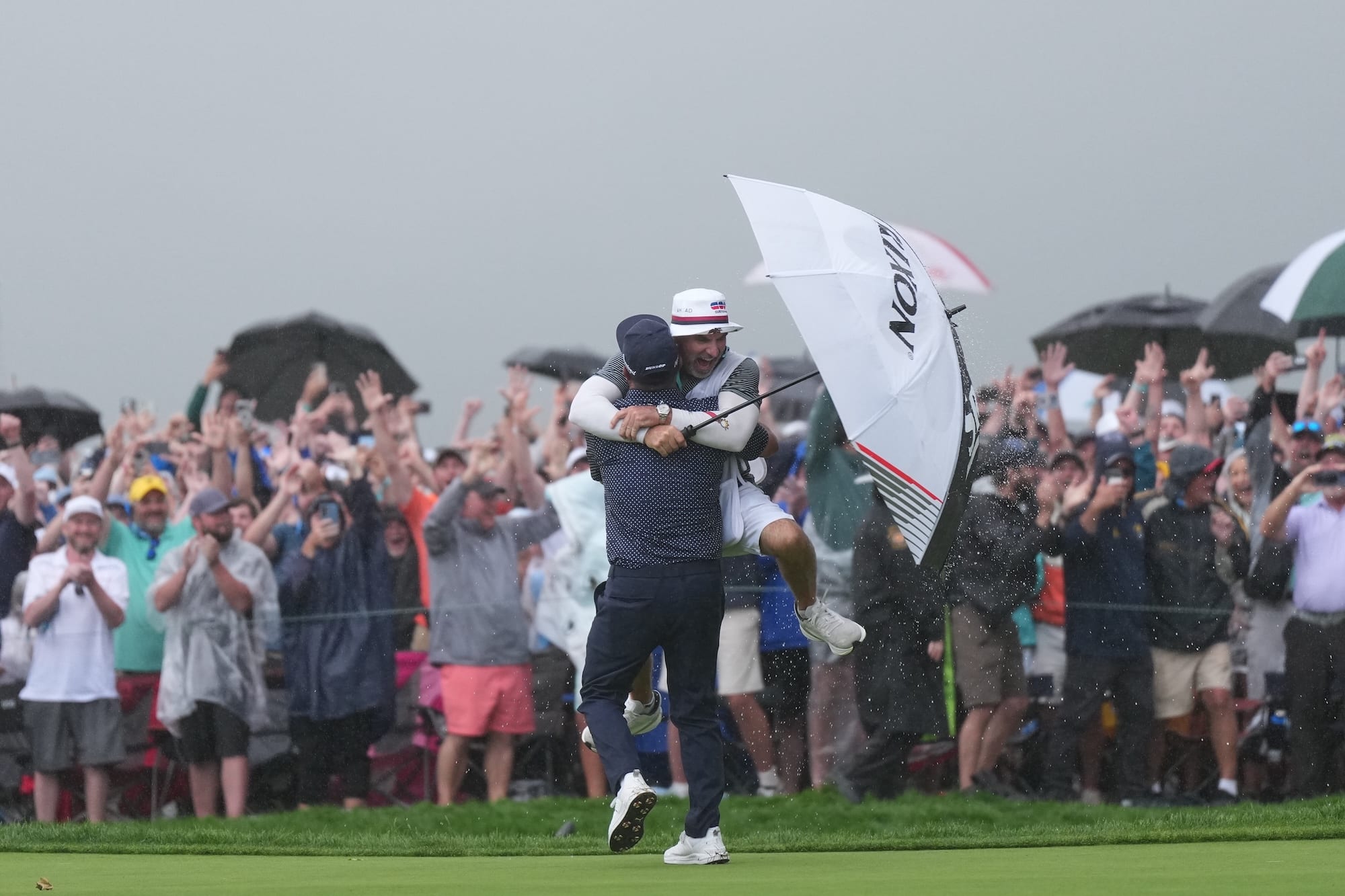 J.J. Spaun and his caddie hug after Spaun's clinching putt at the U.S. Open