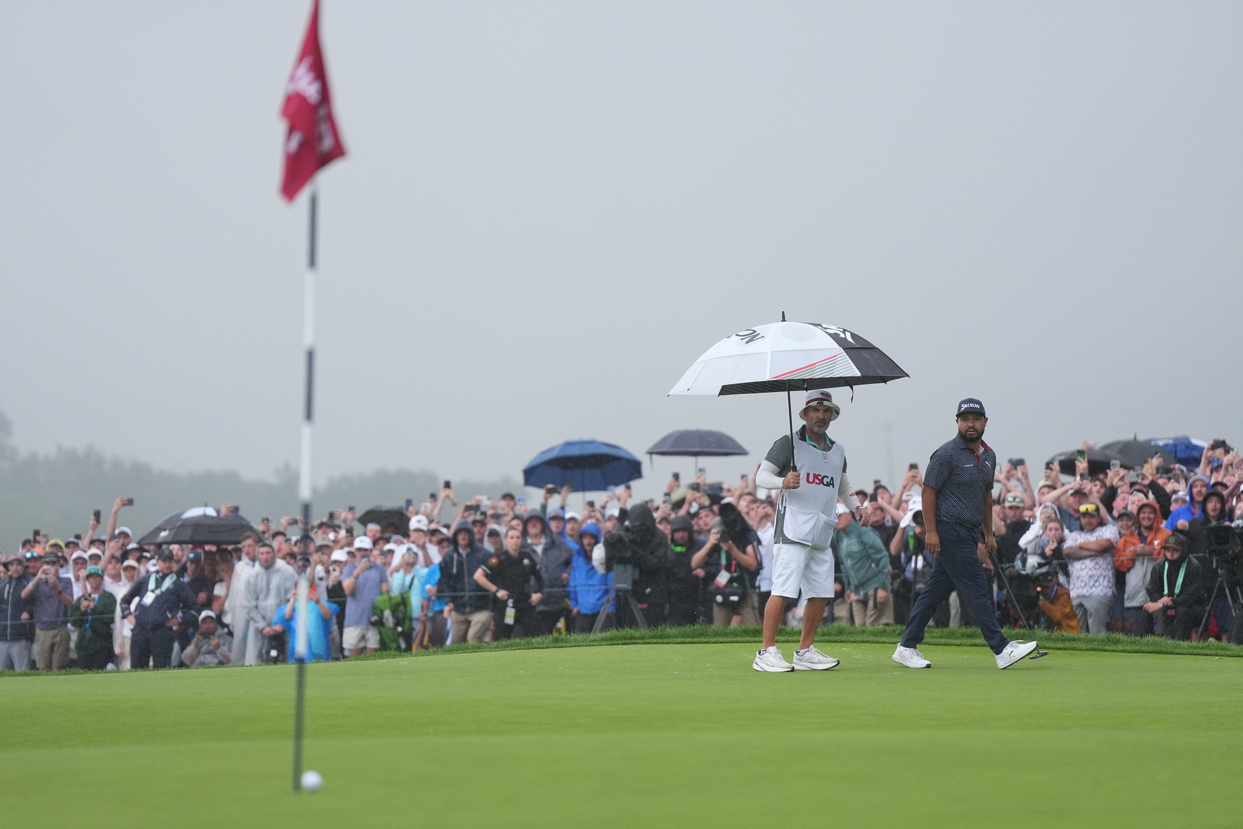 J.J. Spaun sank a 64-foot putt in wet conditions at Oakmont Country Club in Pittsburgh.