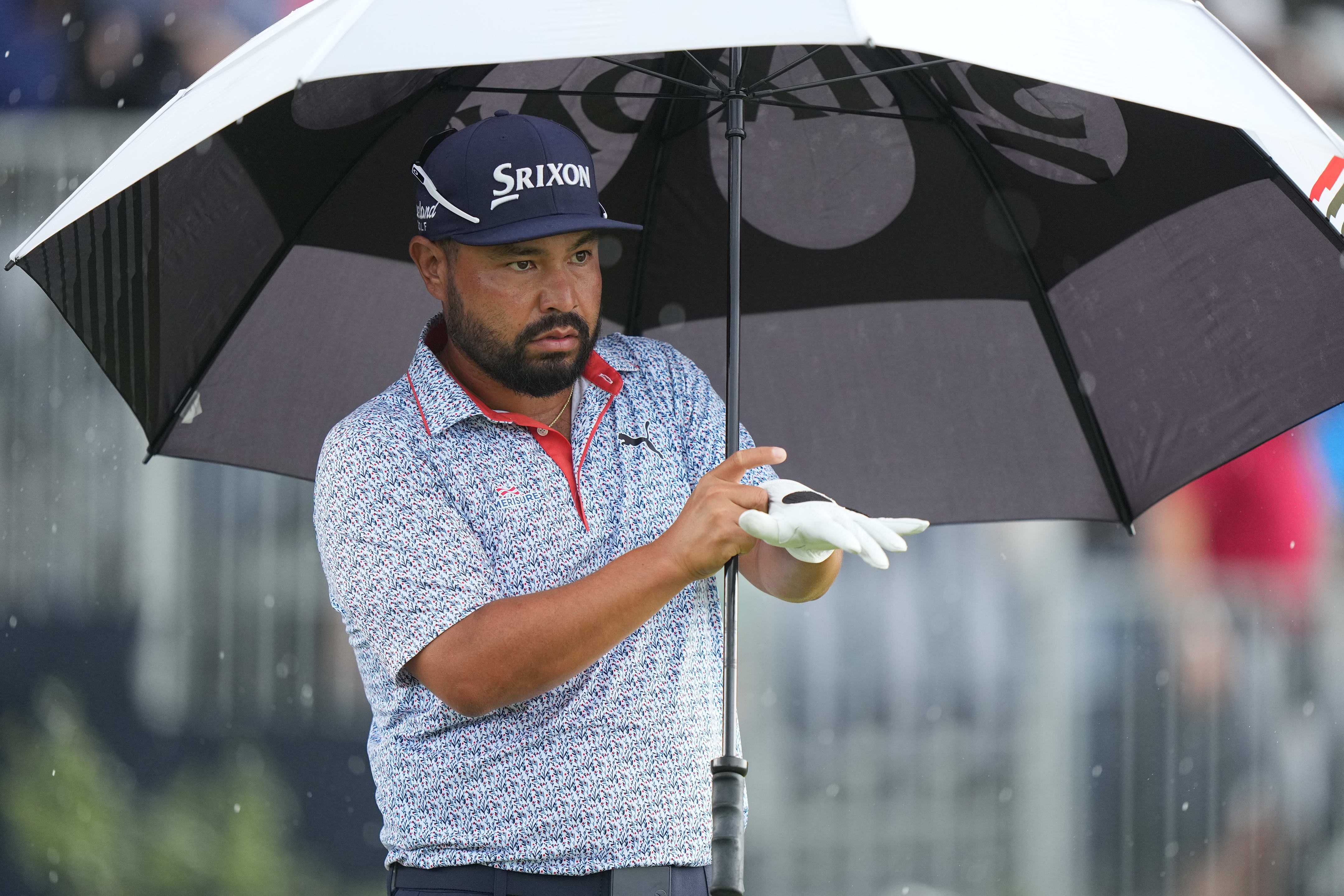 J.J. Spaun readies to hit a shot in the rain at the U.S. Open.