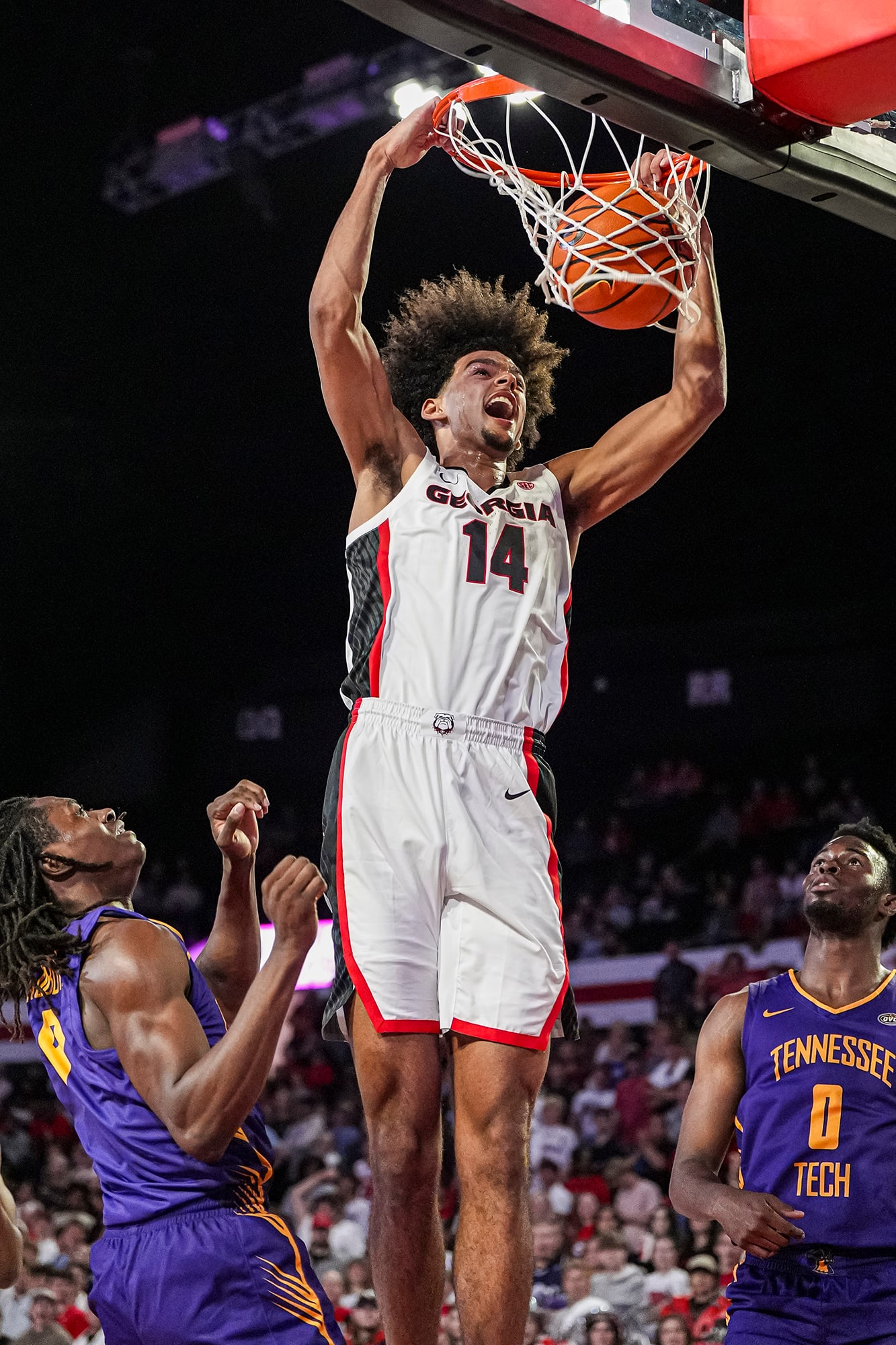 Asa Newell dunks during a college basketball game.