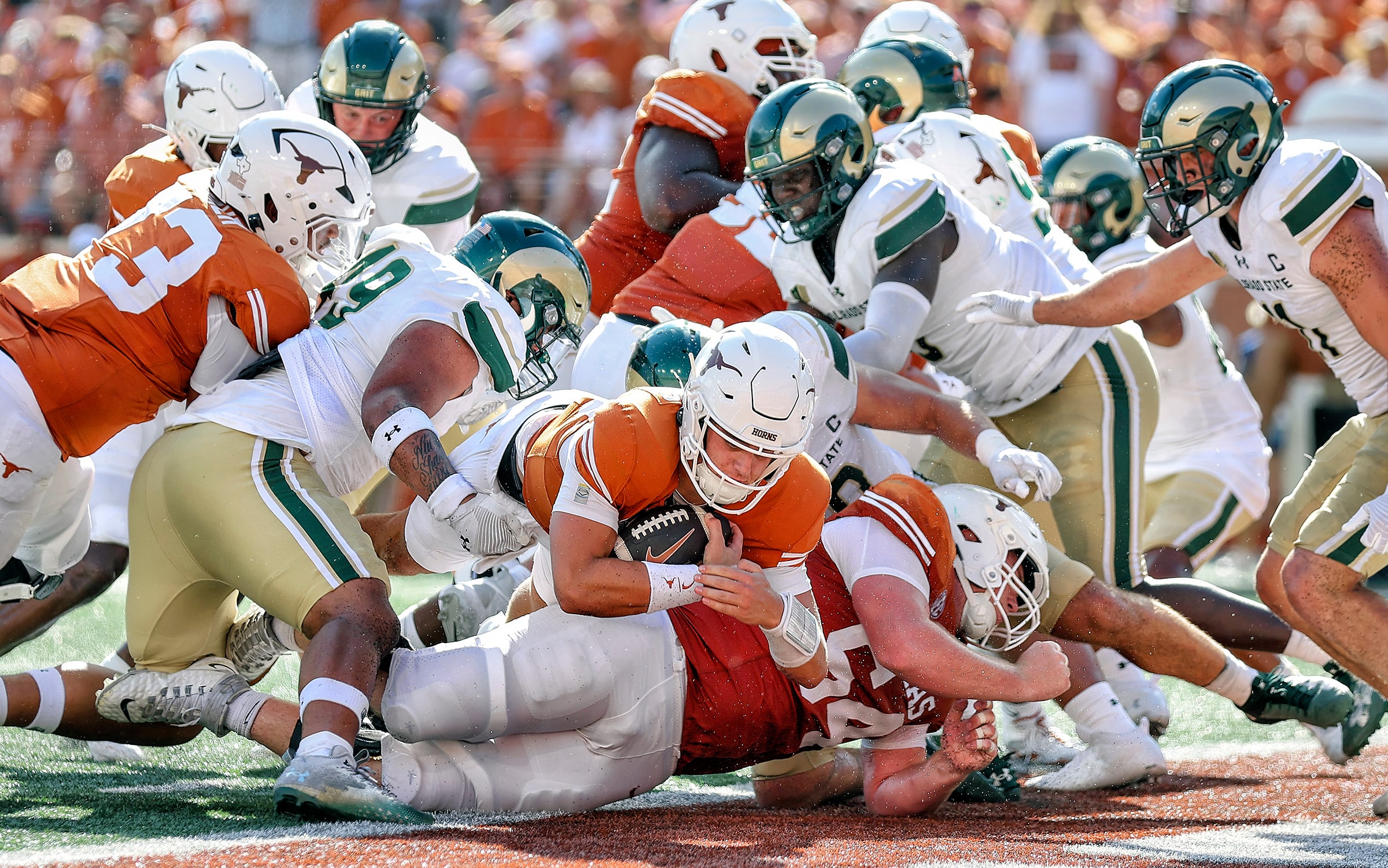 Arch Manning dives into the end zone for a touchdown.