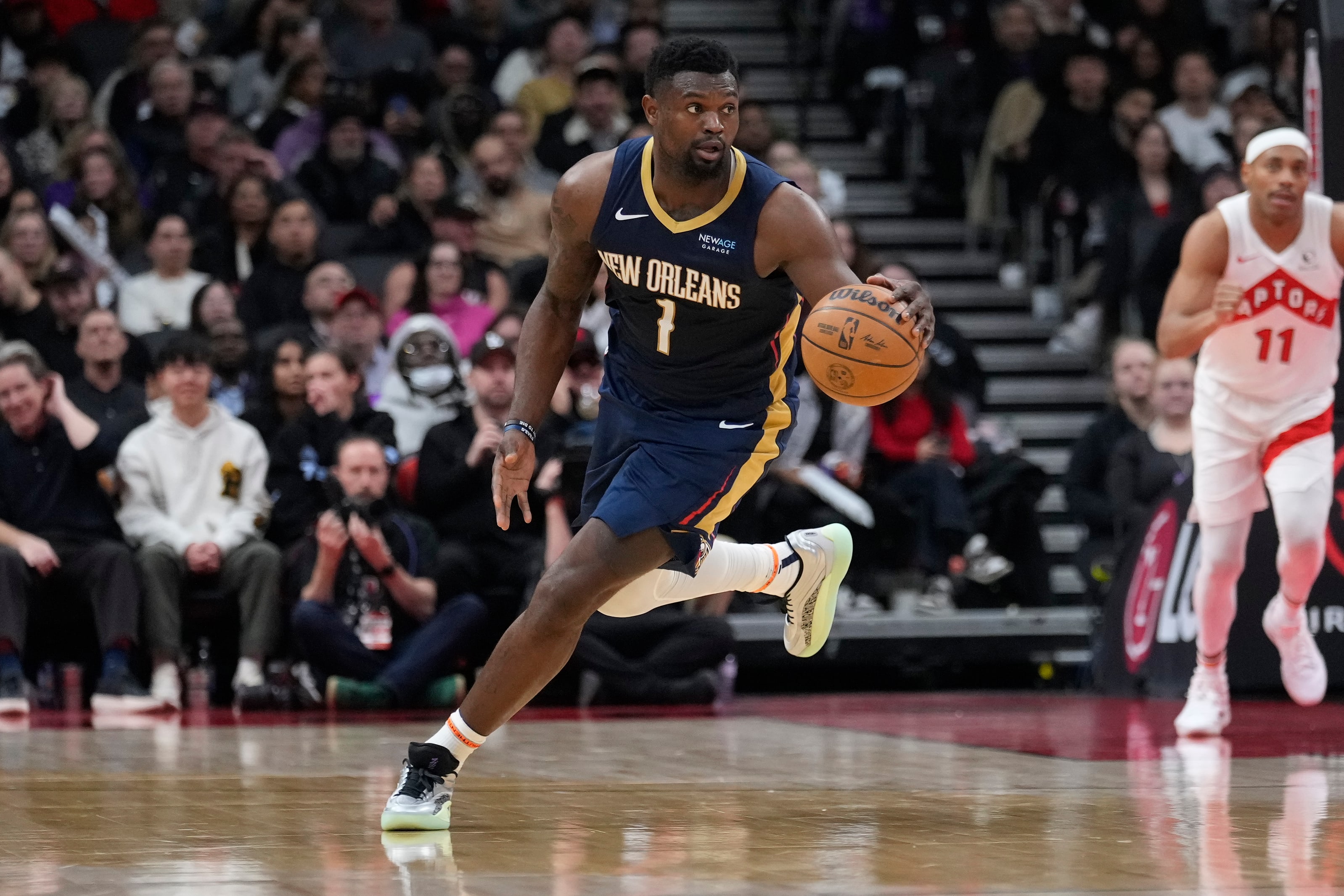 Pelicans forward Zion Williamson dribbles the ball up court against the Raptors.