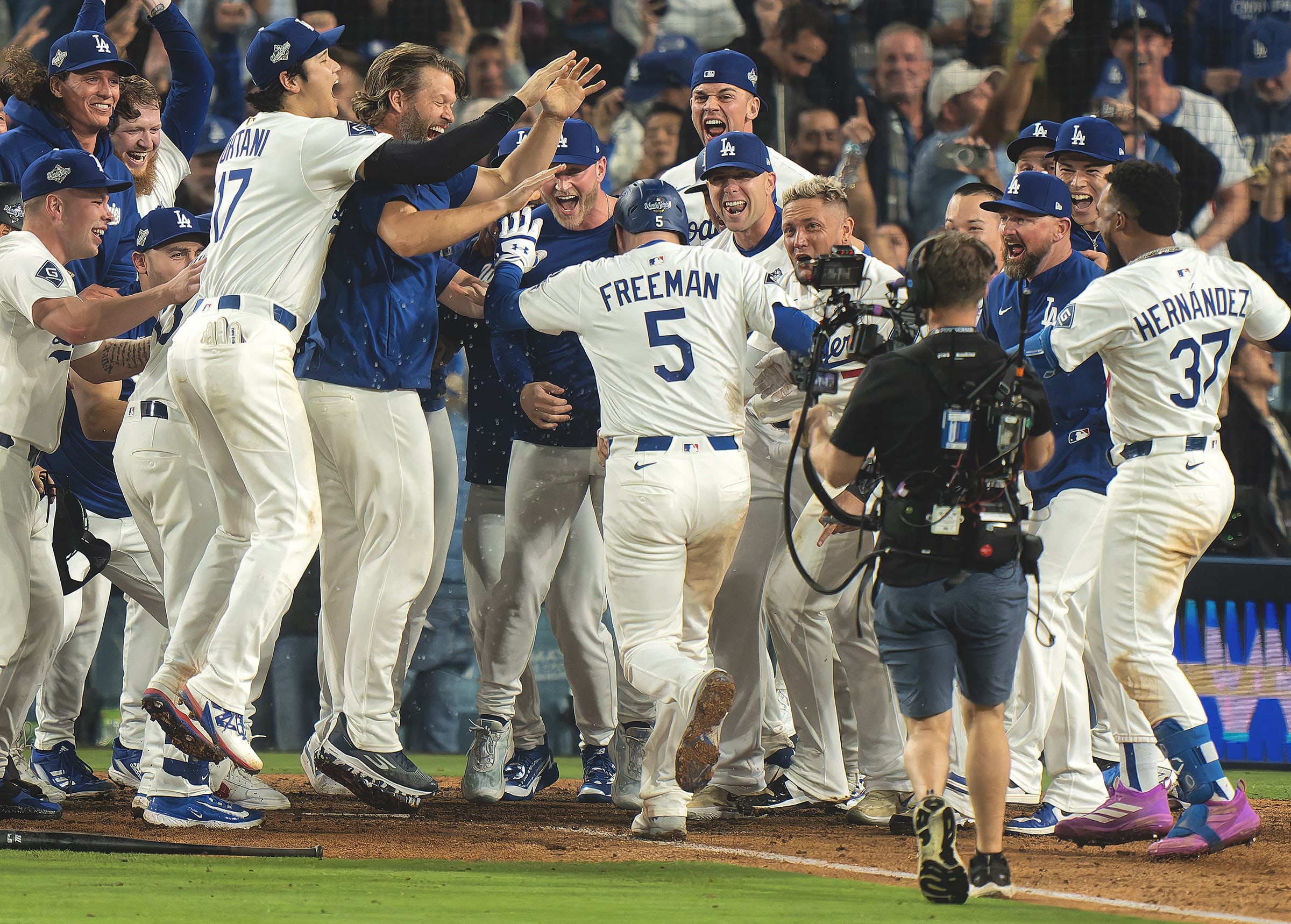 Dodgers players celebrate at the plate after Freddie Freeman's walk-off homer