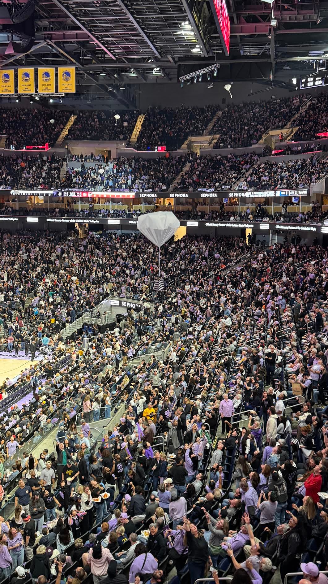 A sold-out crowd attempts to grab a Sephora goodie bag at Valkyries game.