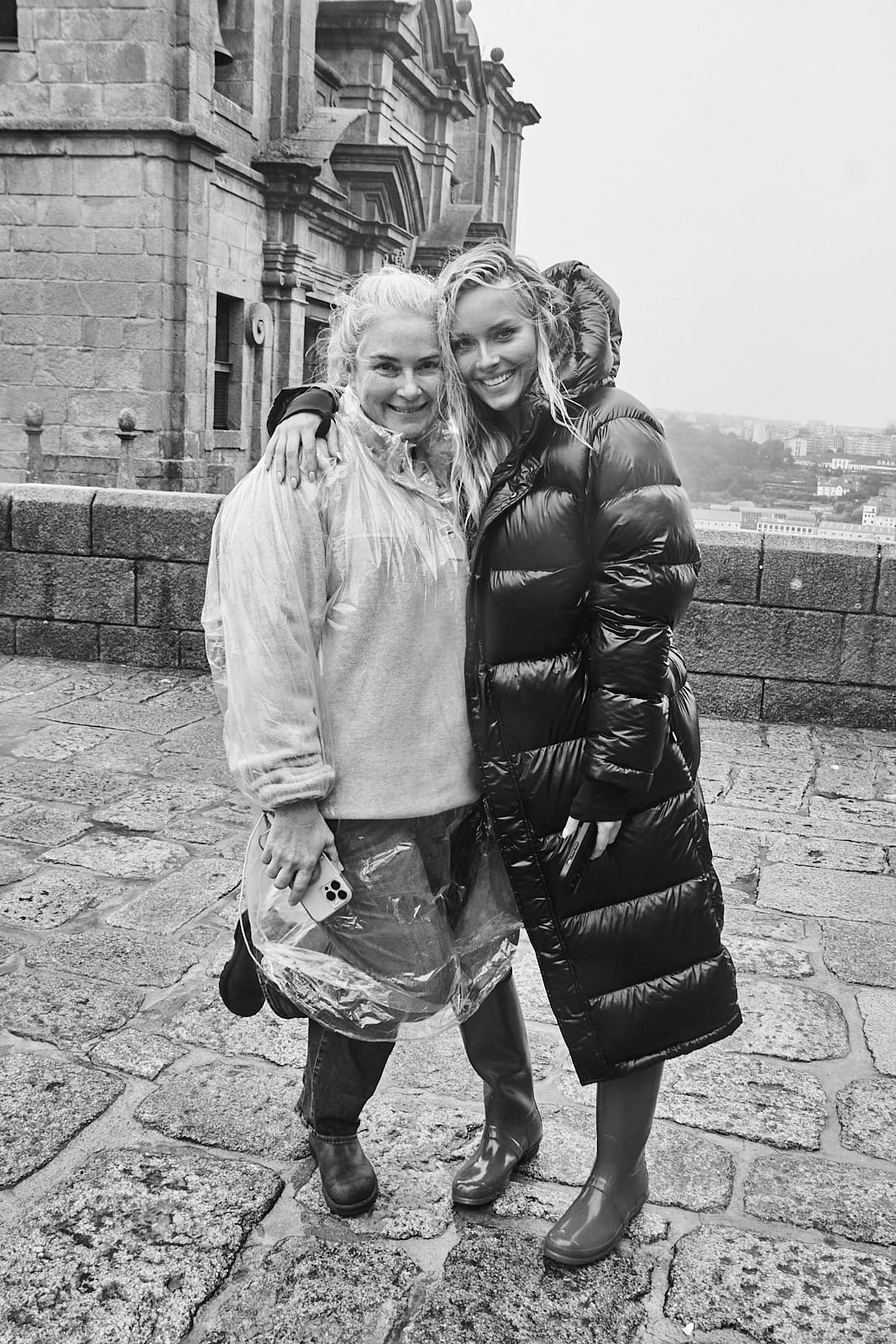 SI Swimsuit editor in chief MJ Day and model Camille Kostek pose in the rain during a photo shoot for the 2024 magazine.