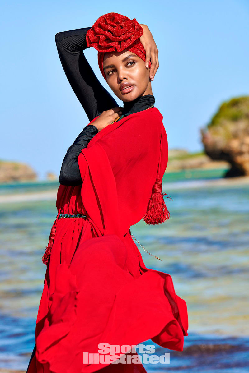 Halima Aden was photographed by Yu Tsai in Kenya. Catsuit by Amazon Fashion. Kimono by Yves Saint Laurent.