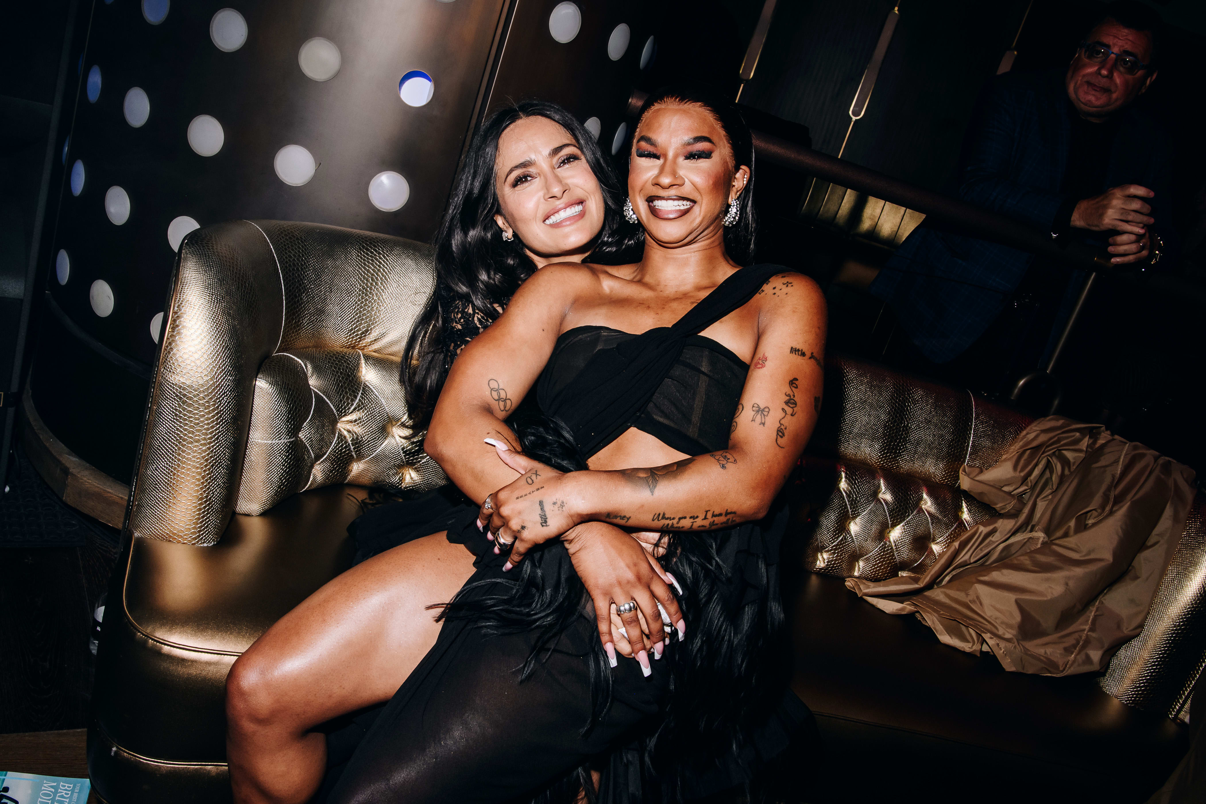 Jordan Chiles sits on Salma Hayek Pinault’s lap