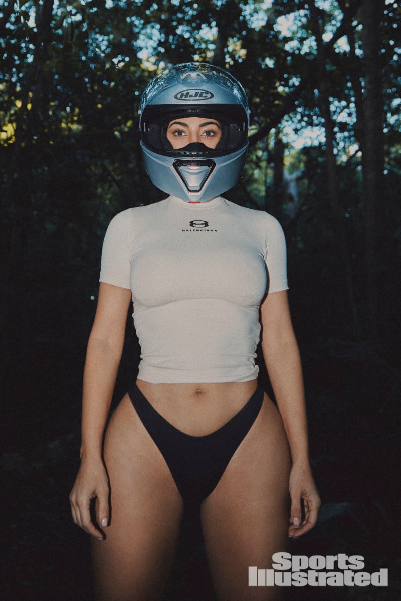 Kim Kardashian was photographed by Greg Swales in the Dominican Republic. Swimsuit by SKIMS. Top by Balenciaga. Helmet by HJC