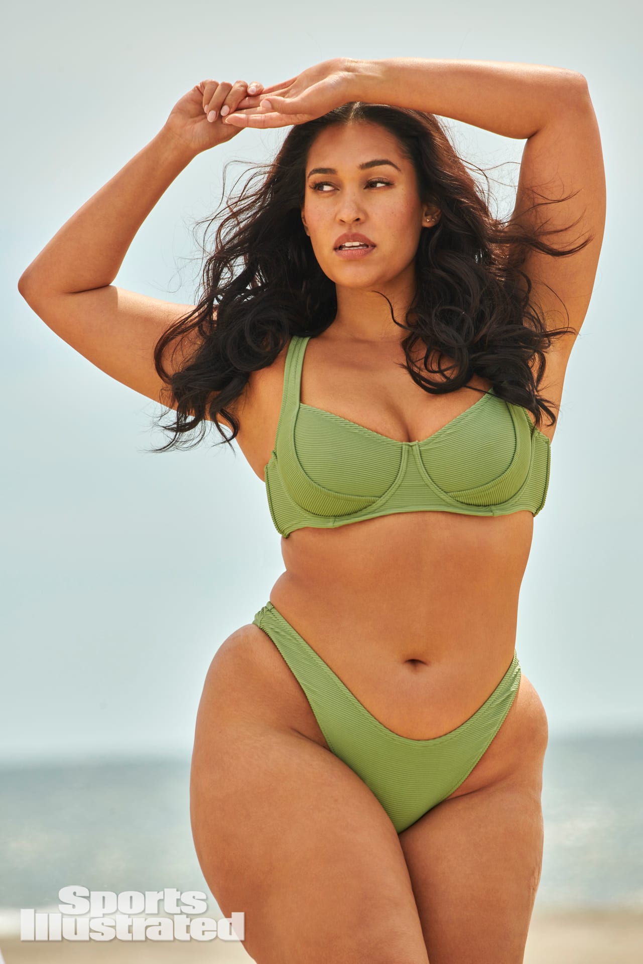 Amanda Kay is wearing a green bikini.