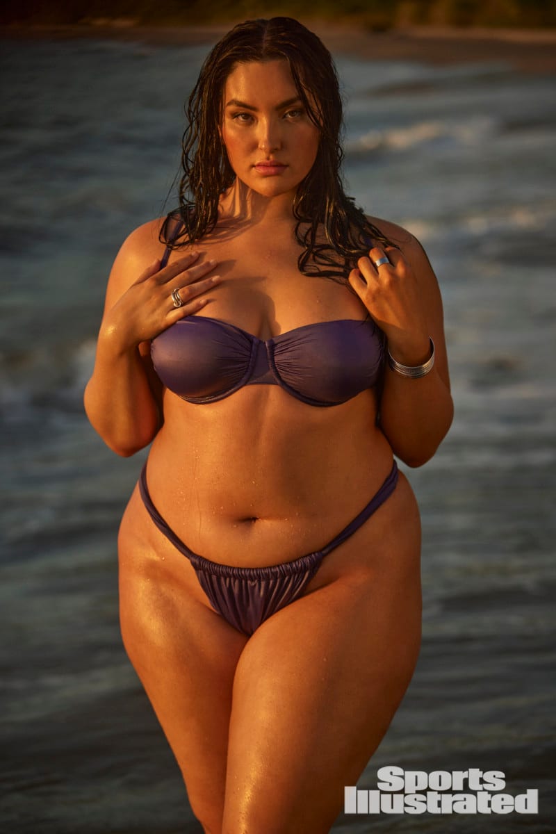 Yumi Nu poses in a purple bikini in the waters of Dominica.