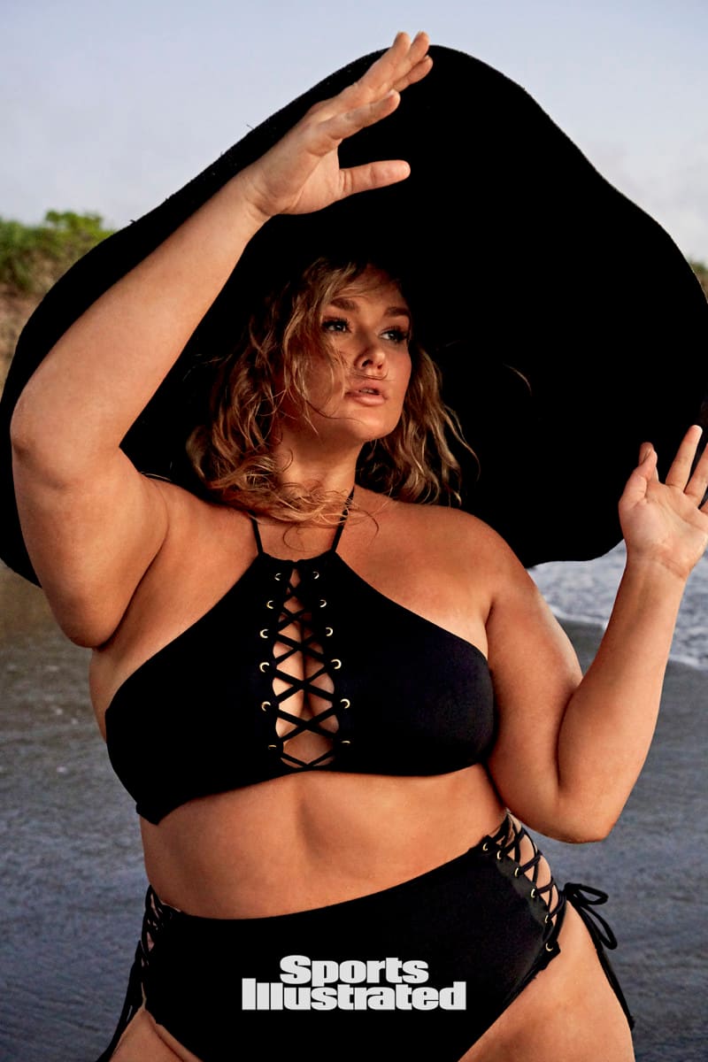 Hunter McGrady is wearing a black swimsuit and black hat.
