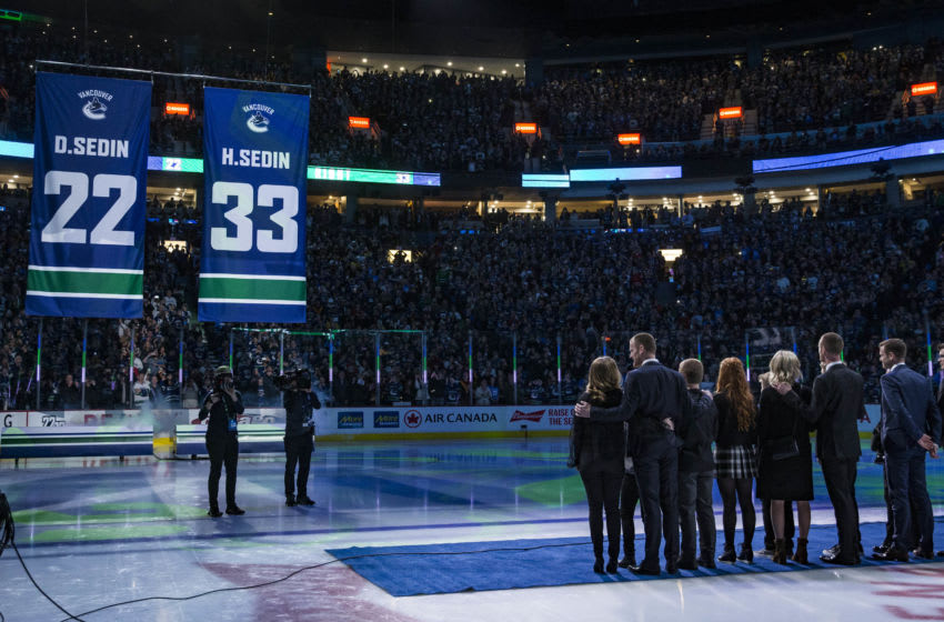 sedins watch as banner is raised