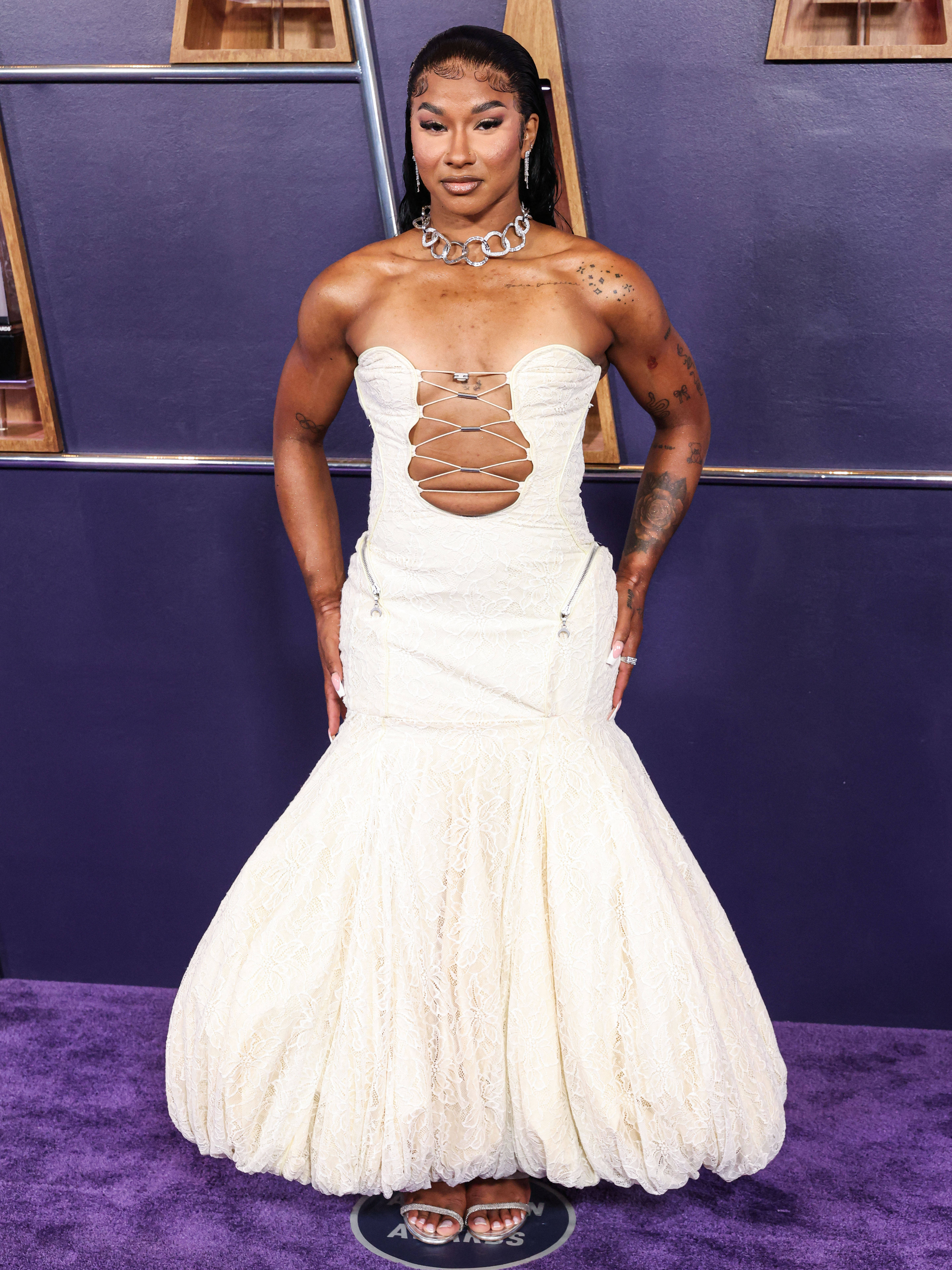 Jordan Chiles flexes white-wedding dress to blood-red backless fit backstage at AMAs Jordan Chiles flexes white-wedding dress to blood-red backless fit backstage at AMAs