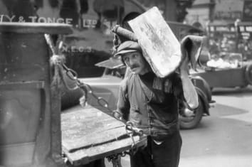 An iceman delivers blocks of ice in 1932.