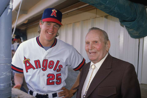 Jim Abbot and Gene Autry stand in the dugout 