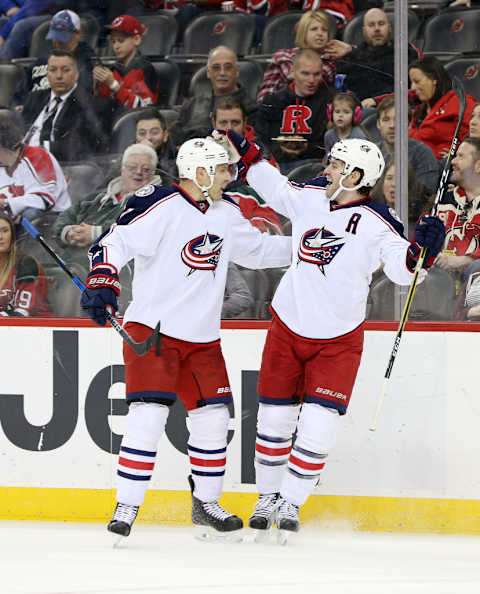 Jack Johnson celebrating with Boone Jenner.