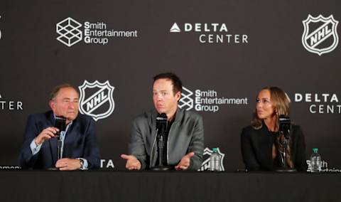 Ryan Smith, seen here flanked by NHL Commissioner Gary Bettman and wife Ashley Smith, is leaving the decision on Utah's team name in the hands of fans.