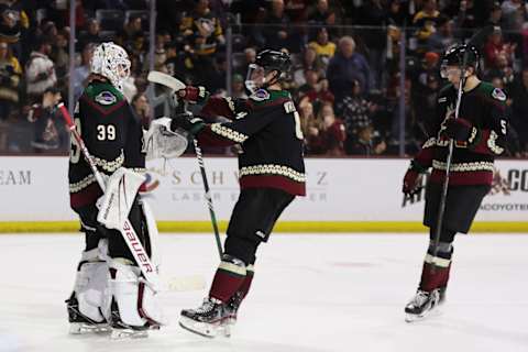 Juuso Valimaki and Michael Kesselring celebrate a Coyotes win with Connor Ingram.