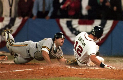 The Atlanta Braves Sid Bream (R) slides across the