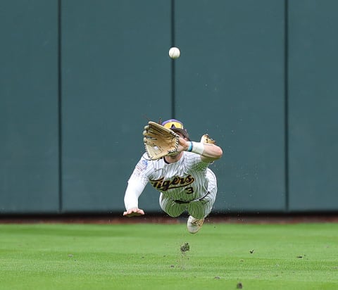 Top draft prospect Dylan Crews attempts a diving catch.