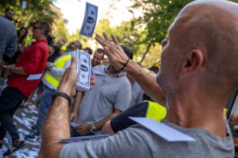 A taxi driver is seen throwing photocopies of a dollar bill...