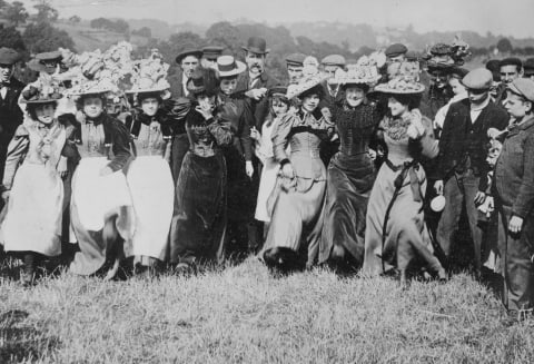 A holiday crowd, complete with Easter bonnets, dancing on London's Hampstead Heath in 1892.