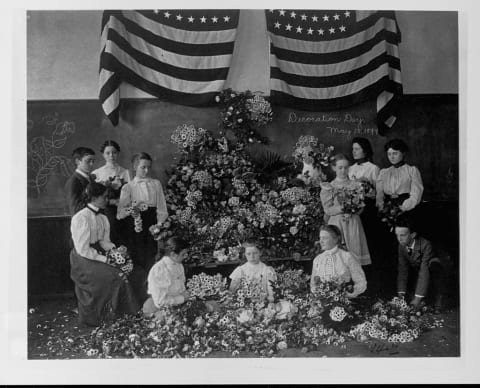 Schoolchildren gather flowers for Memorial Day.