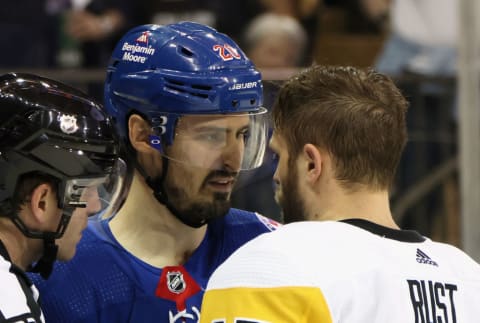 Chris Kreider and Bryan Rust, possibly chirping. 