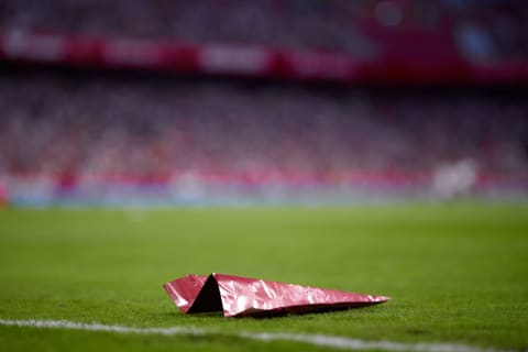 A paper airplane on a field.