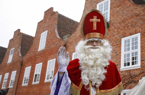 Sinterklaas waves as he visits the Dutch.