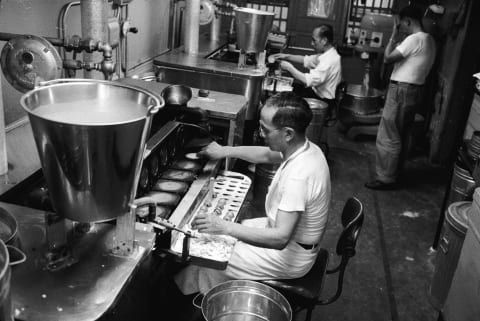 Fortune cookies being made via machine, 1955.