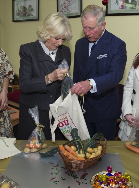 Charles and Camilla packing produce for Christmas hampers in 2012.