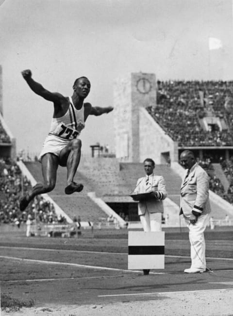 Jesse Owens competes in the long jump at the 1936 Summer Olympics.