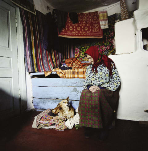 Zinayida Trofimivna Huzienko, 93, talks to her dog inside of her home in the village of Ilintsi near Chernobyl, Ukraine, in 2006.